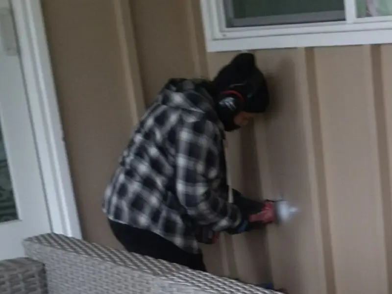 Professional electrician installing an exterior outlet in Henniker